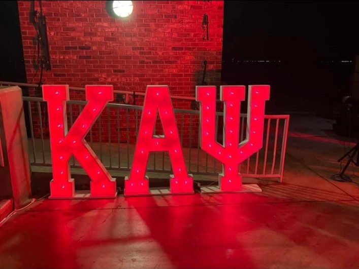 Illuminated Kappa Alpha Psi Greek letters at Spring Kreme
